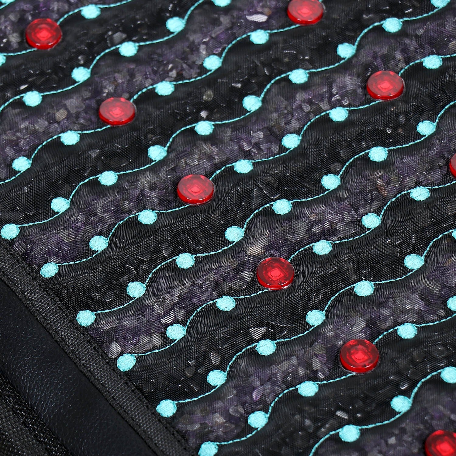 Close-up of a textured surface with red and blue circular patterns